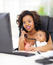 successful young african american businesswoman with baby at office